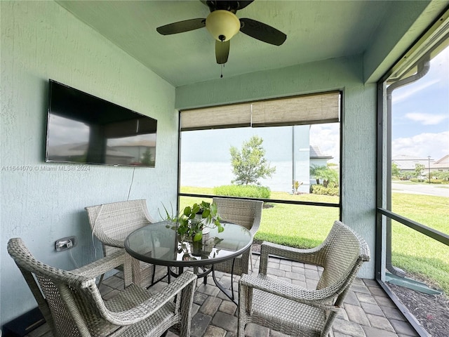 sunroom featuring a ceiling fan