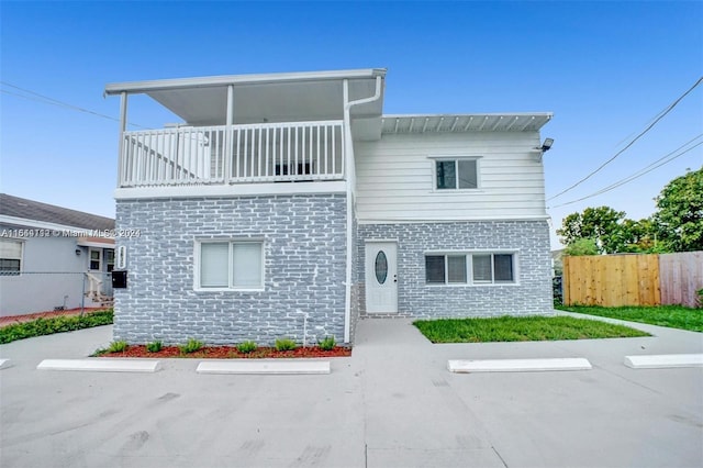 exterior space featuring a patio area and a balcony