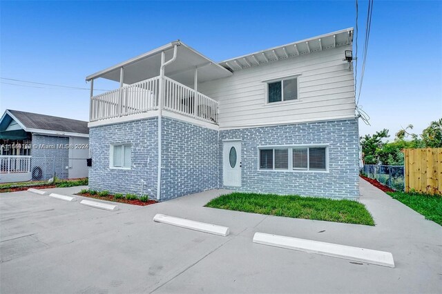 back of property with a balcony