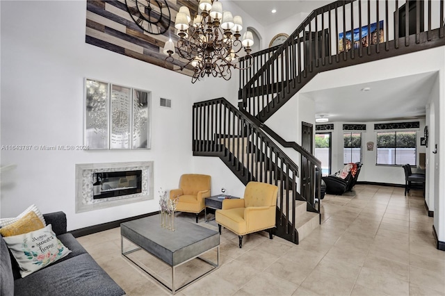 tiled living room featuring a towering ceiling and a notable chandelier