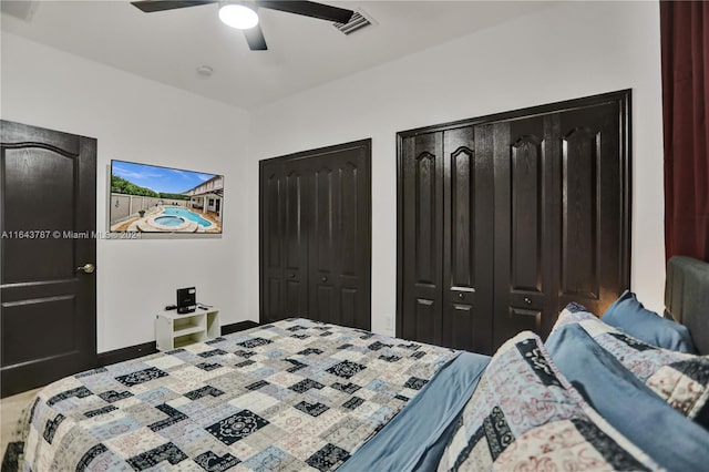 bedroom featuring multiple closets and ceiling fan