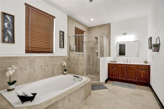 bathroom with tile patterned floors, vanity, and separate shower and tub