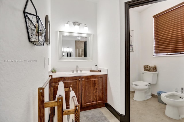 bathroom featuring vanity, a bidet, and toilet