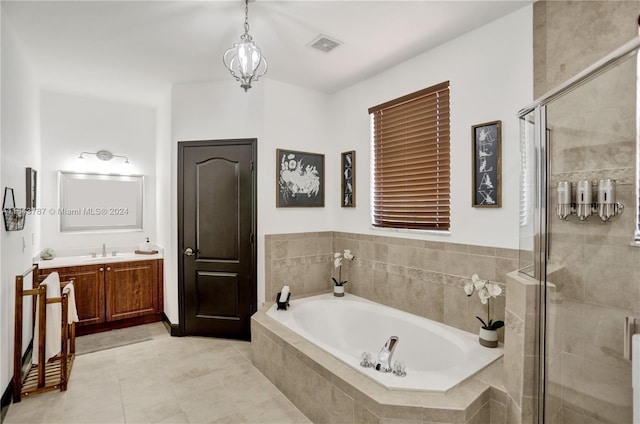 bathroom featuring tile patterned flooring, vanity, and shower with separate bathtub