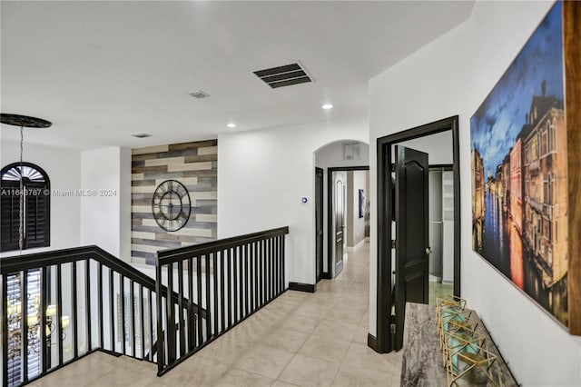 corridor featuring light tile patterned floors