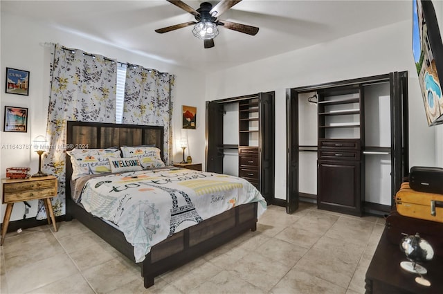 tiled bedroom featuring ceiling fan and two closets