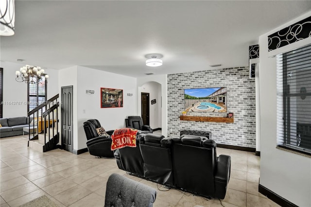 tiled living room with brick wall and a chandelier