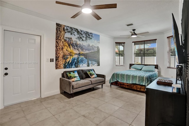 tiled bedroom with ceiling fan and crown molding