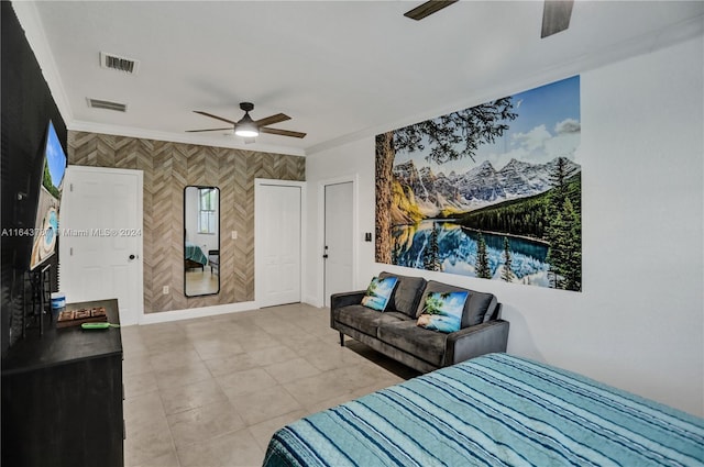 tiled bedroom with ceiling fan and crown molding