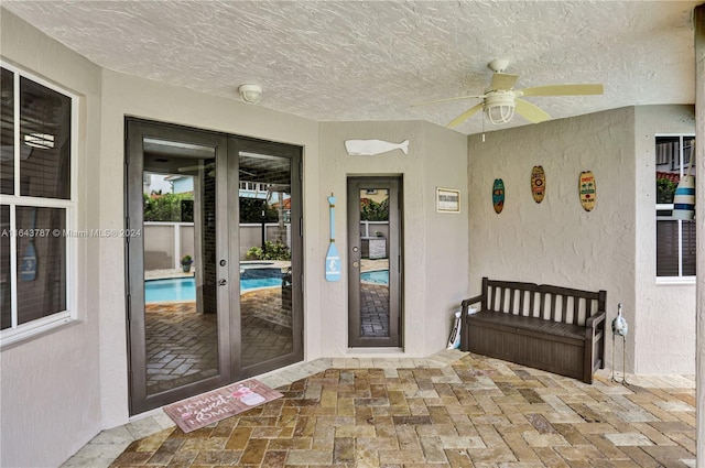 doorway to property featuring ceiling fan