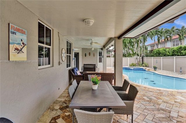 view of swimming pool with ceiling fan and a patio area