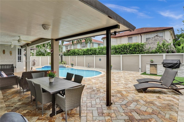 view of patio / terrace featuring a fenced in pool and ceiling fan