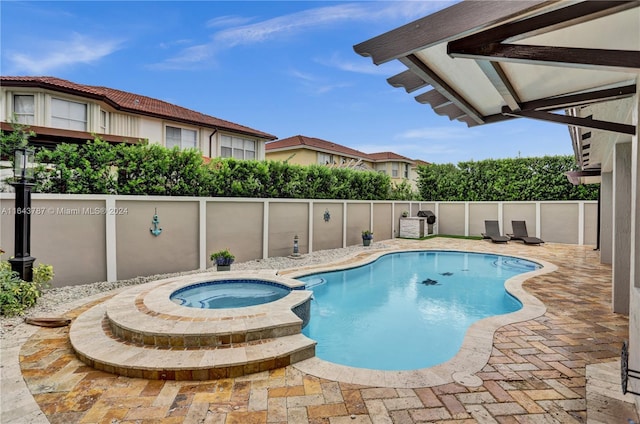 view of swimming pool featuring an in ground hot tub