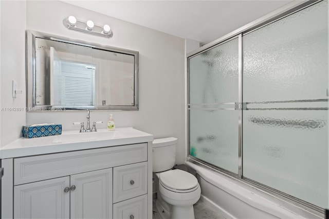 full bathroom with tile patterned floors, enclosed tub / shower combo, vanity, and toilet