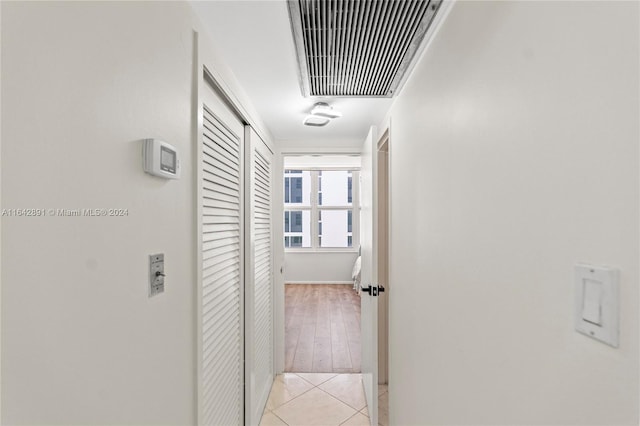 hallway with light hardwood / wood-style floors