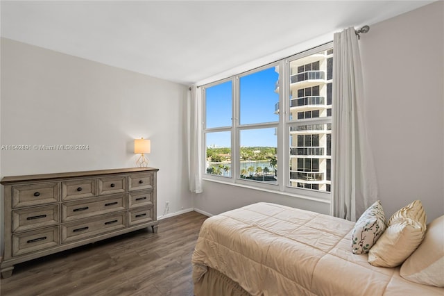 bedroom with dark wood-type flooring