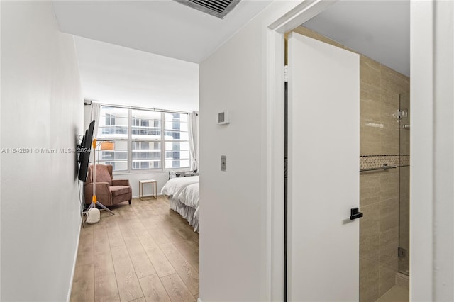 interior space featuring light hardwood / wood-style floors and connected bathroom