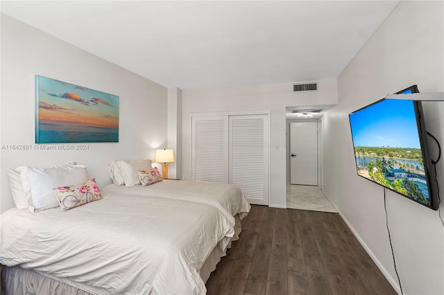 bedroom with a closet and hardwood / wood-style floors