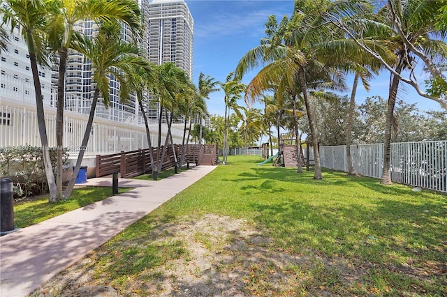 view of property's community featuring a playground and a lawn