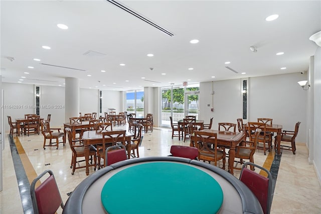 game room with expansive windows and light tile patterned floors