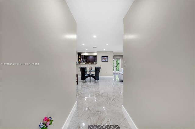 hall with light tile patterned floors