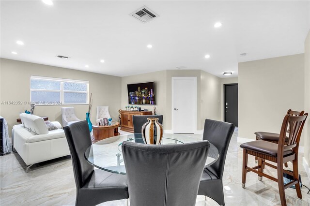 dining space featuring light tile patterned flooring