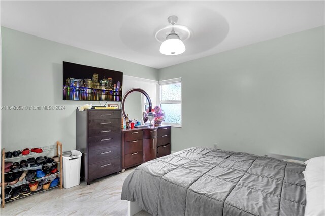 tiled bedroom with ceiling fan