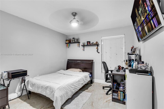 tiled bedroom with ceiling fan