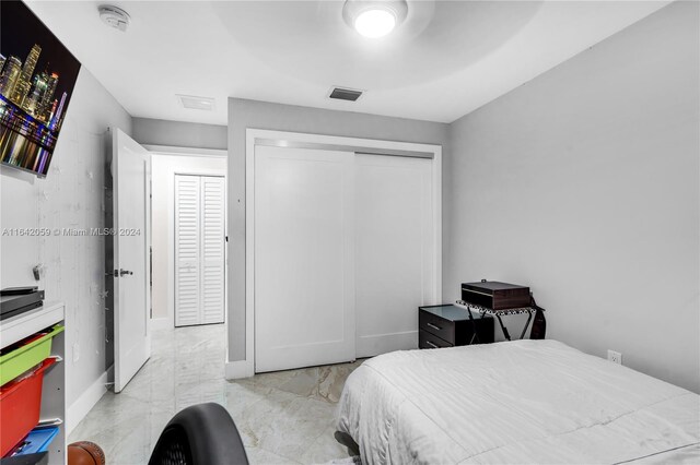 bedroom with light tile patterned floors and a closet