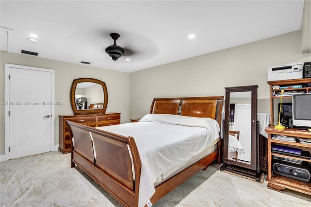 bedroom with ceiling fan and light tile patterned floors