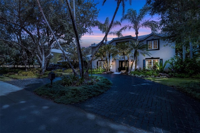 view of front of property featuring decorative driveway and stucco siding