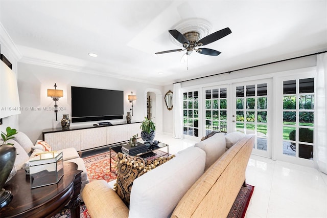 tiled living area featuring arched walkways, french doors, crown molding, recessed lighting, and a ceiling fan