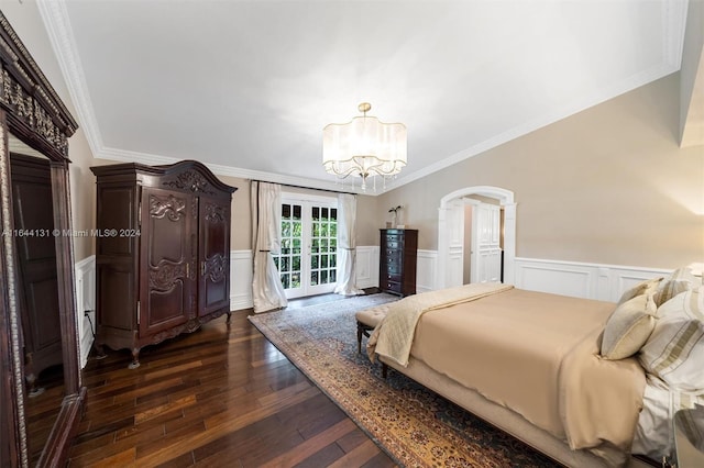 bedroom featuring access to exterior, dark wood finished floors, ornamental molding, wainscoting, and a chandelier