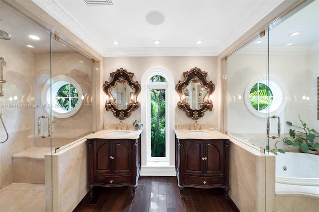 full bath with ornamental molding, a sink, a shower stall, and hardwood / wood-style floors