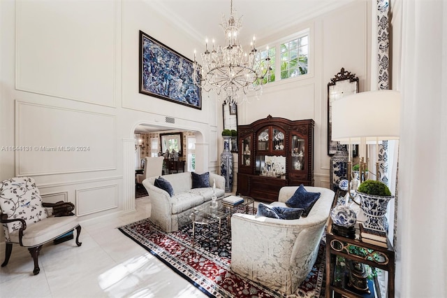 living room featuring arched walkways, ornamental molding, tile patterned floors, and a decorative wall