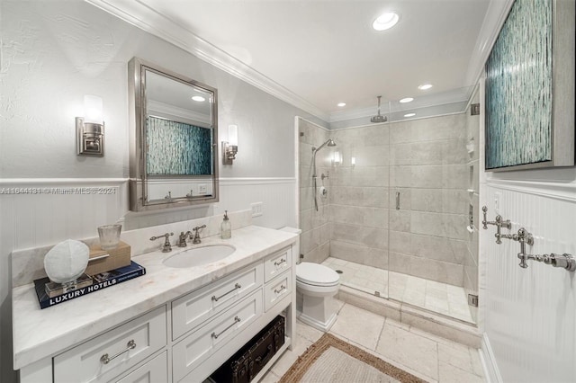 full bathroom with ornamental molding, wainscoting, a shower stall, and vanity