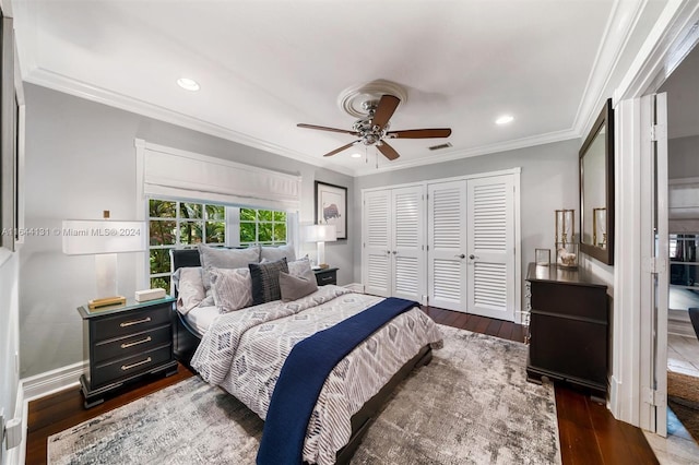 bedroom with multiple closets, recessed lighting, dark wood-style flooring, and crown molding