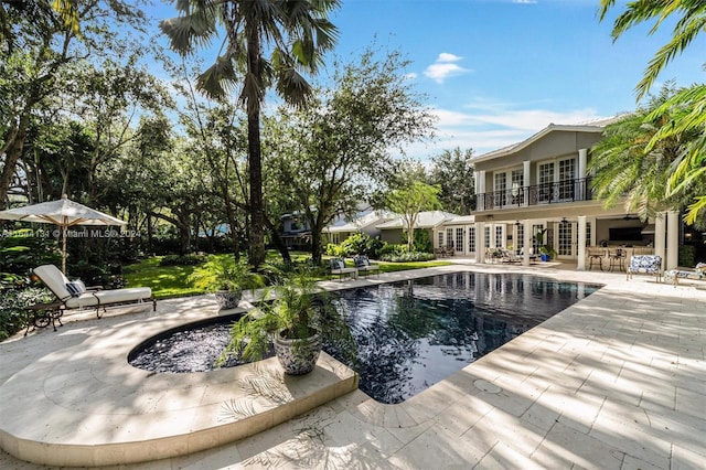 outdoor pool featuring french doors and a patio area