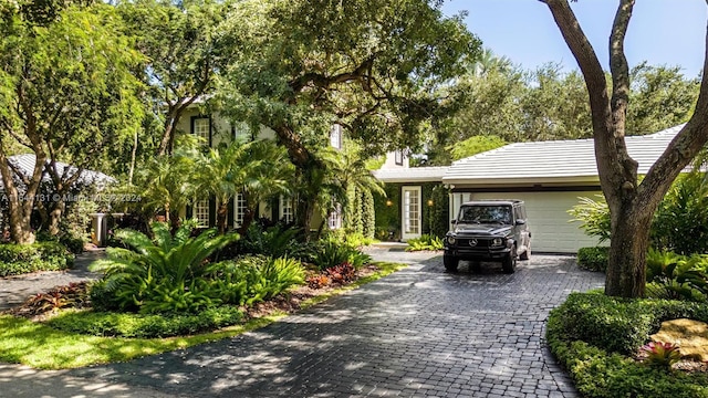 view of front of house featuring decorative driveway and an attached garage