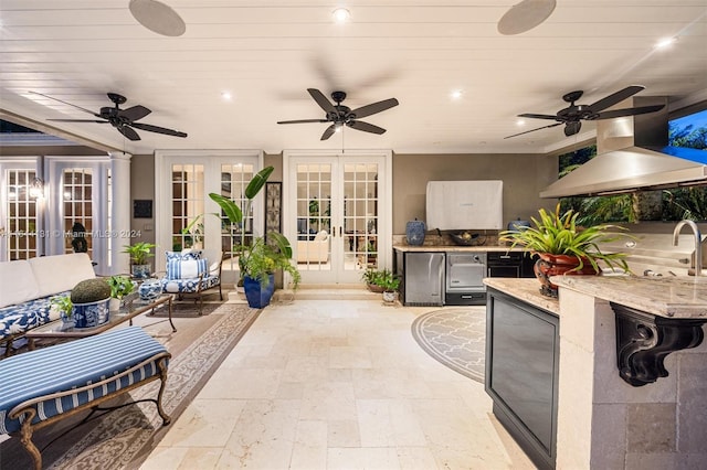 view of patio / terrace with a ceiling fan, exterior kitchen, and french doors