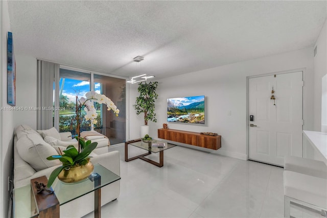 living room featuring light tile patterned floors and a textured ceiling