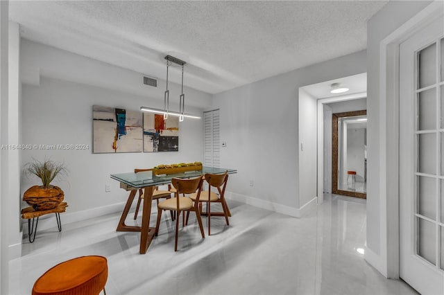 dining area with a textured ceiling