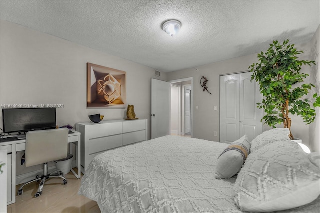 bedroom with a closet and a textured ceiling