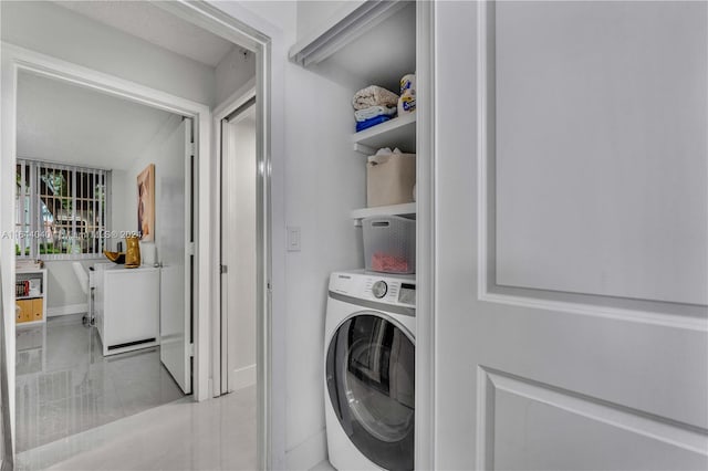 clothes washing area featuring light tile patterned floors and washer / clothes dryer