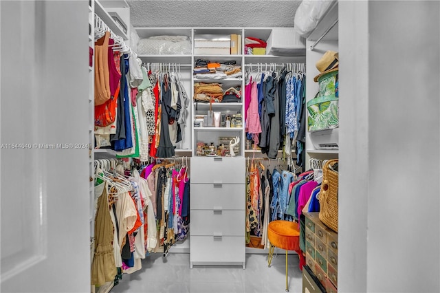 walk in closet featuring light tile patterned flooring