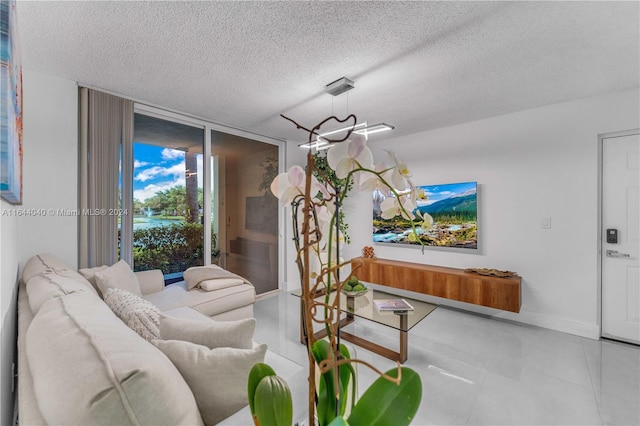 living room featuring tile patterned flooring, a textured ceiling, and floor to ceiling windows