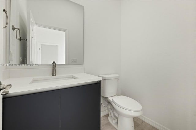 bathroom with toilet and vanity