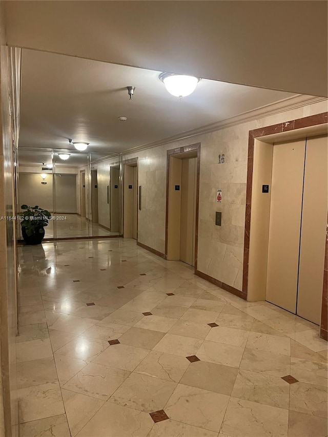 interior space featuring light tile patterned floors, ornamental molding, and elevator