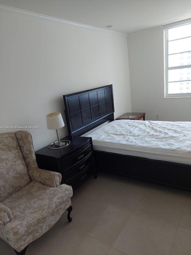 bedroom featuring crown molding and tile patterned floors