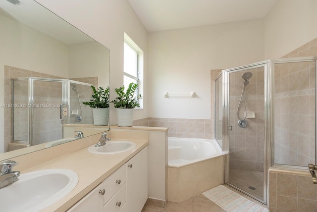 bathroom with plus walk in shower, double sink vanity, and tile patterned flooring